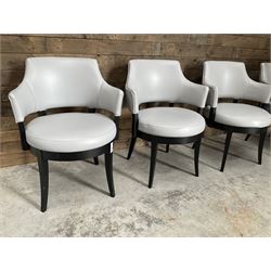 Four ebonised framed tub shaped armchairs, upholstered in grey fabric