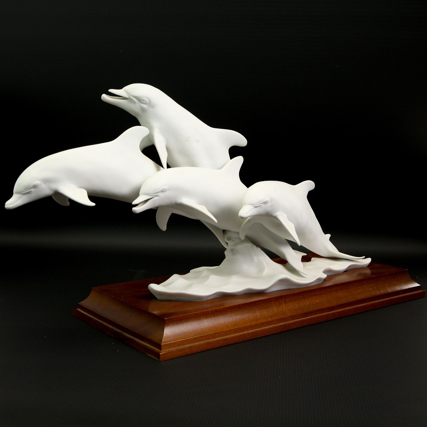 Kaiser limited edition porcelain group of four bottlenose dolphins on wooden stand No.306/4500 with incised signature W40cm and a Kaiser vase No.618 with incised signature to base H28cm (2)