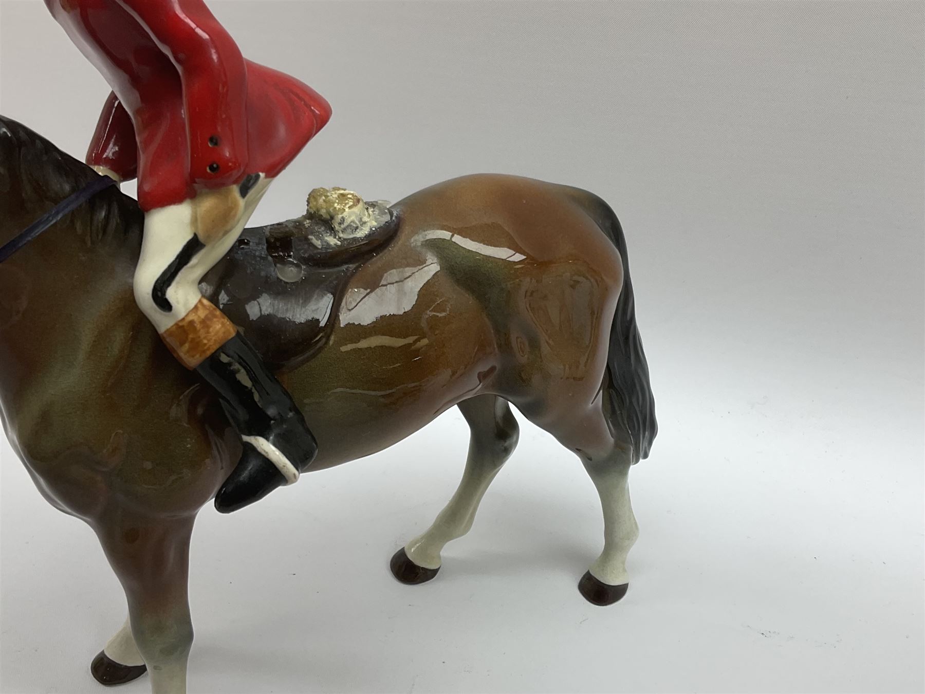 Beswick Hunting Group, comprising: two huntswoman on grey horses, model no 1730, huntsman on a bay horse, model no 1501, a seated fox, model no 1748, eighteen fox hounds and a spaniel, model no 967, all with printed marks beneath, together with three other ceramic huntsman on horseback and two hounds. 