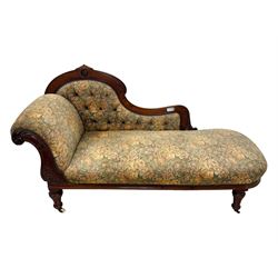 Victorian Aesthetic Movement mahogany framed chaise longue, shaped carved back over acanthus scrolled arm terminal, upholstered in floral patterned tapestry fabric with sprung seat, on turned and fluted supports with castors