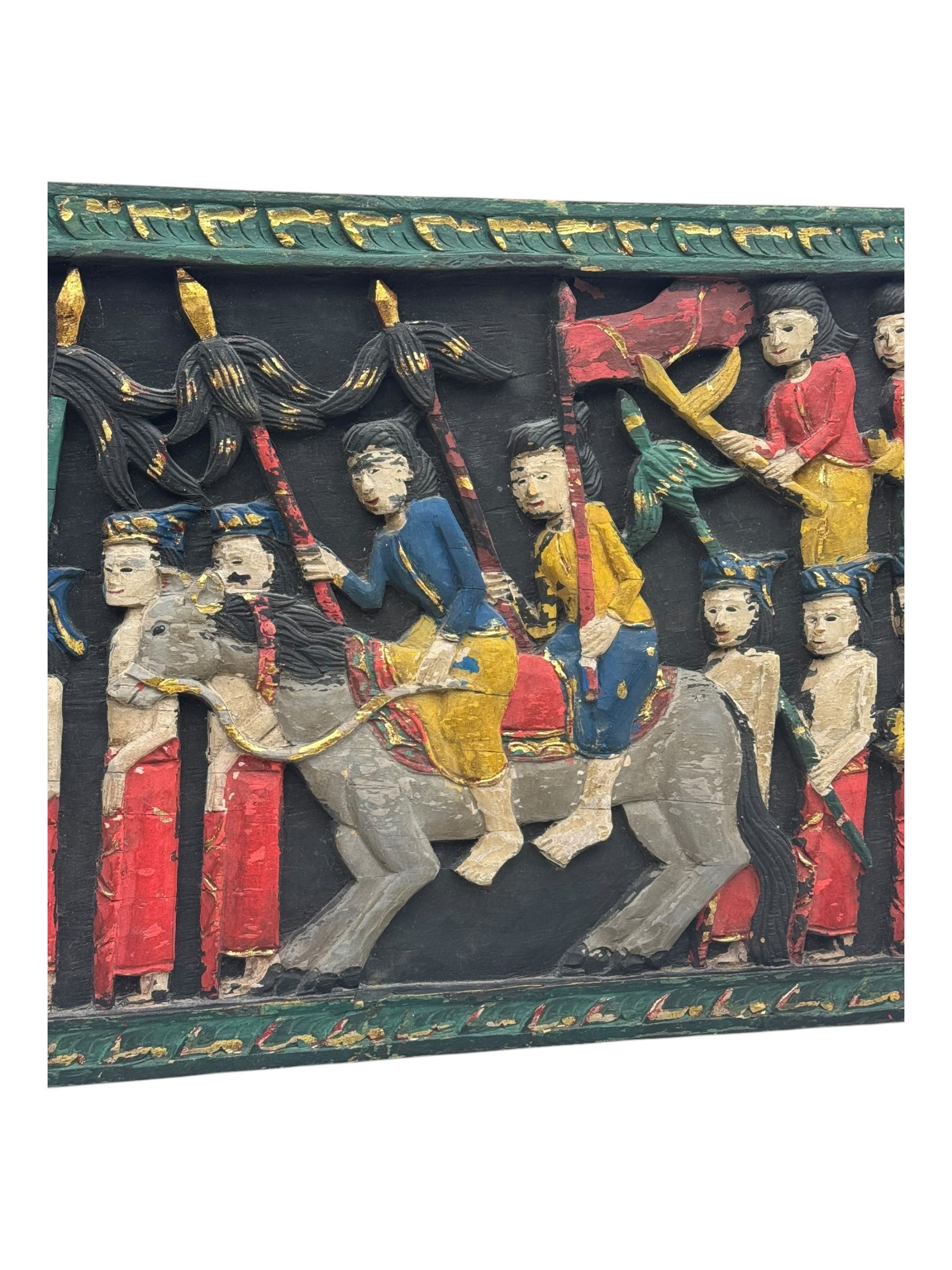 Rectangular relief carved and painted wall hanging panel, depicting ceremonial procession with soldiers and flag bearers on horses and elephants