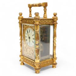 French - Edwardian 8-day timepiece carriage clock in a brass case with glazed side and rear door panels, brass foliate embellished dial mask with a circular enamel dial, Roman numerals and retailers name (indistinct), minute track and steel hands, with a cylinder platform escapement, wound and set from the rear.  