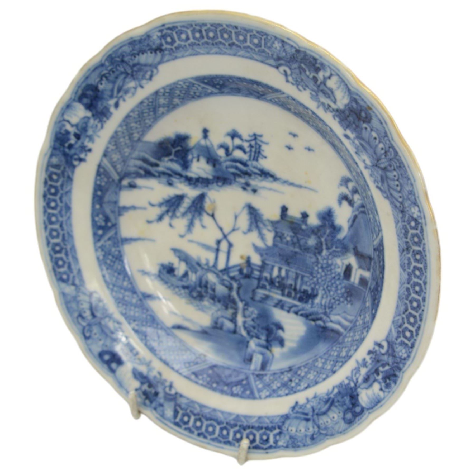 18th century Chinese Export blue and white part dinner service, comprising four soup bowls, four tea plates, sauceboat and stand, five dinner plates, D24cm, five bowls and a smaller plate, each decorated with pagodas and figures in a landscape, within foliate and cell borders, together with three matching 18th century Chinese Export rectangular platters, max L29cm (24)