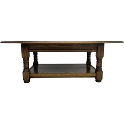 Traditional oak coffee table, moulded oval top, four turned pillar supports united by undertier