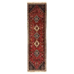 Persian Qashqai crimson ground runner, the field decorated with repeating diamond-shaped m...