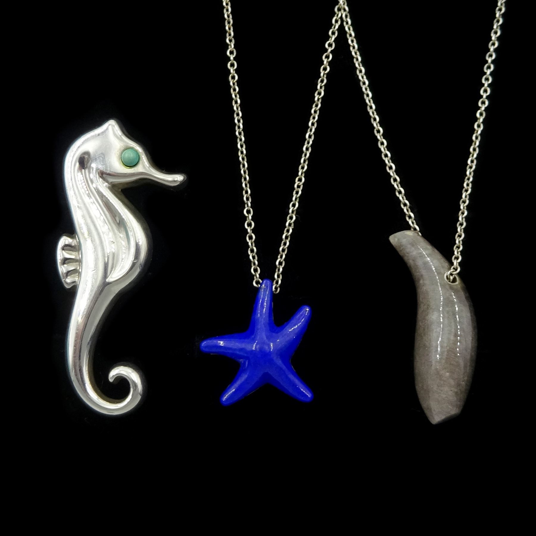 Tiffany & Co silver jewellery including jade Fish pendant by Frank Gehry, lapis lazuli Starfish pendant by Elsa Peretti, both on Peretti silver chain necklaces and a seahorse pendant, all boxed with pouches 