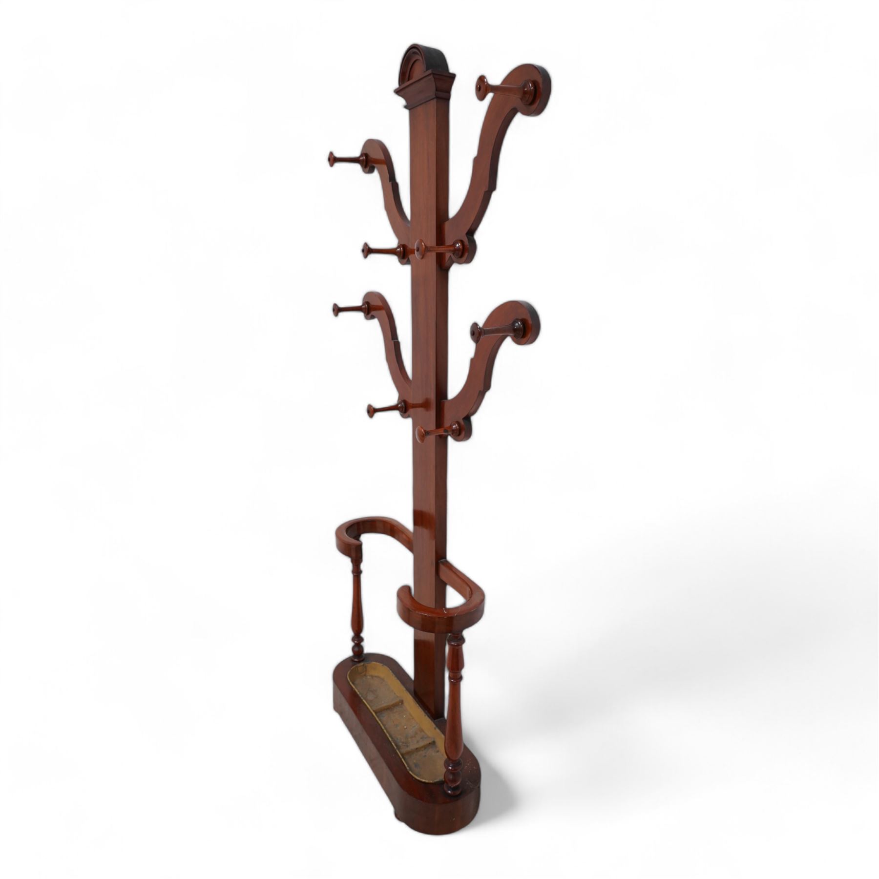 Victorian mahogany hall stand, central rectangular pillar supporting four projecting branches with turned hat and coat hooks, lower stick and umbrella stand on turned supports with metal drip tray, skirted base on compressed bun feet 