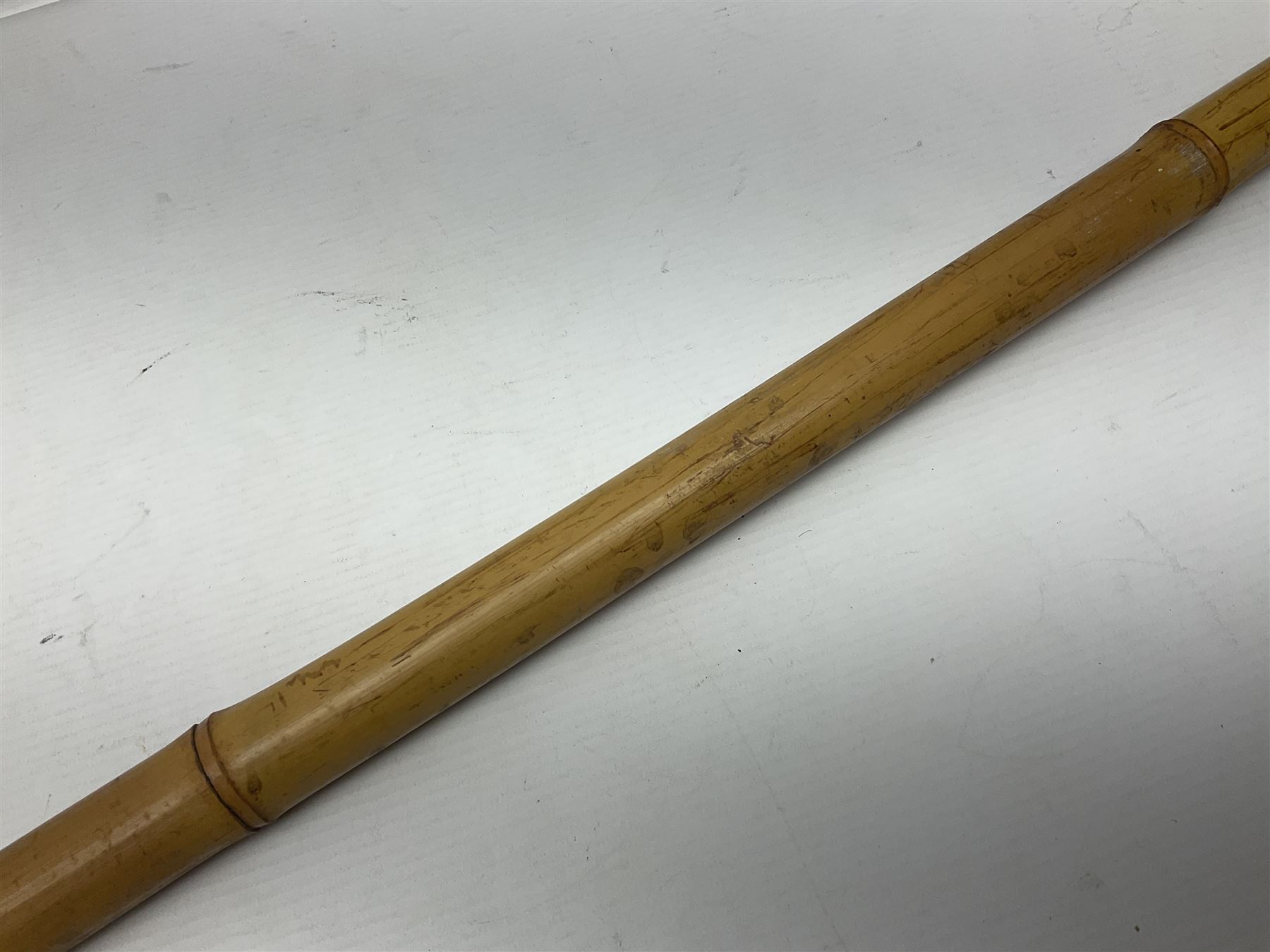 Bamboo cane torch, the pierced brass cover opening to reveal a wick, H144cm