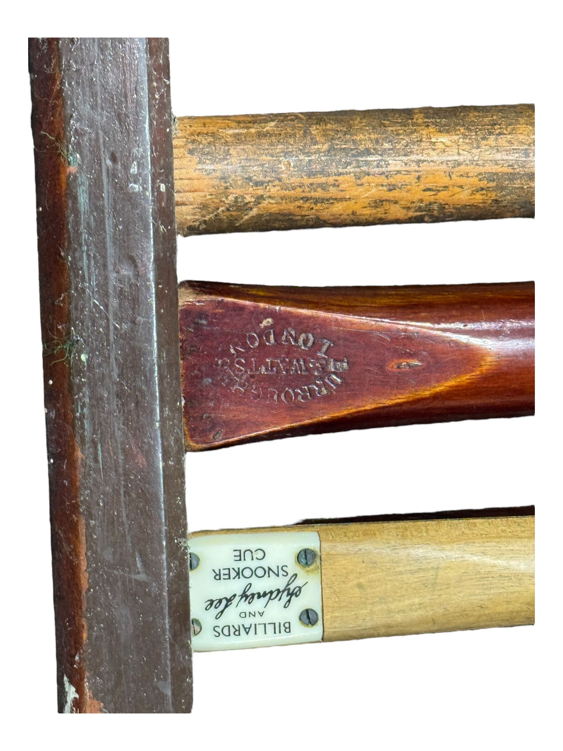 Riley - early 20th century full-sized mahogany billiards or snooker table, on eight turned baluster supports, with cue rack, scoreboard, balls and various cues 