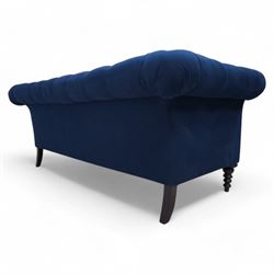 Chesterfield two-seat sofa, traditional shape with rolled arms, upholstered in deep blue buttoned fabric, on black finish turned front feet 