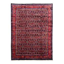 Persian indigo ground rug, the field decorated all over with floral Heratti motifs, crimso...