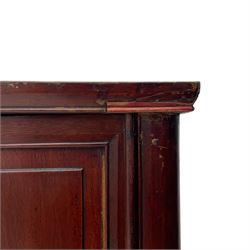 Pair of early 20th century Chinese red lacquered elm storage cupboards, rectangular top over two panelled doors, fitted with two internal drawers, on square supports with curved outer edge, panelled sides