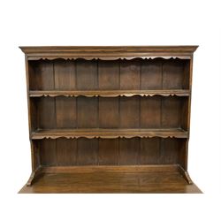 Georgian design oak dresser, two-tier plate rack with shaped aprons, the base fitted with two fielded moulded drawers, over two panelled cupboards carved with scrolling acanthus leaves, with guilloche carved central upright, on stile feet