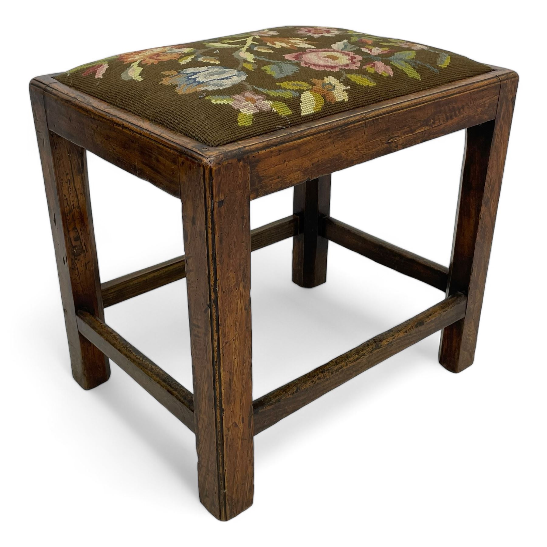 19th century country elm stool, rectangular form with drop-in seat upholstered in floral needlework, moulded frame and supports, united by plain stretchers 