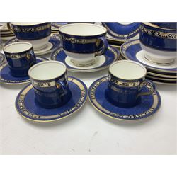 Wedgwood part tea and coffee service, comprising coffee pot, six coffee cans with five saucers, seven teacups with ten saucers and seven side plates, each decorated with floral bouquet to centre, in a gilt and speckled blue border, pattern x9933, with printed mark beneath