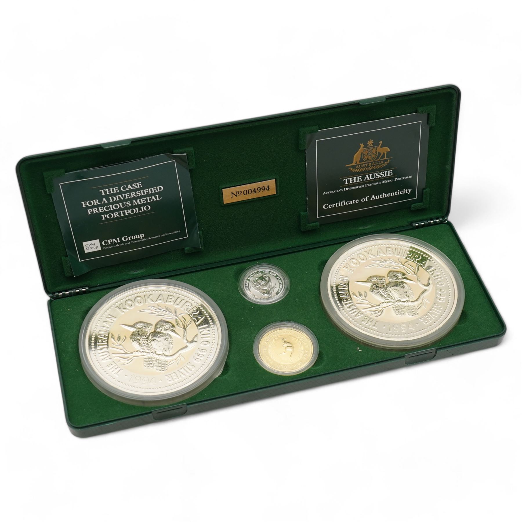 'The Aussie Australia's Diversified Precious Metal Portfolio' comprising two one kilogram fine silver kookaburras, two ounce fine gold kangaroo nugget and one ounce fine platinum koala, housed in a green plastic display case with certificates