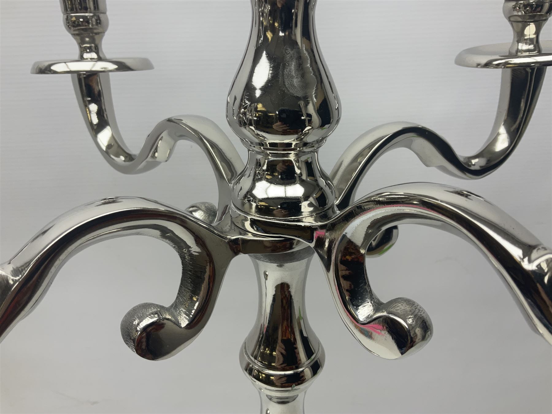 Pair of four branch candelabras, urn-shaped nozzles raised upon scroll branches supported from tapering central stem, with circular base, H70cm