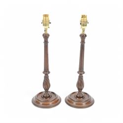 Pair of 19th century style mahogany candlestick table lamps, each with turned and fluted c...