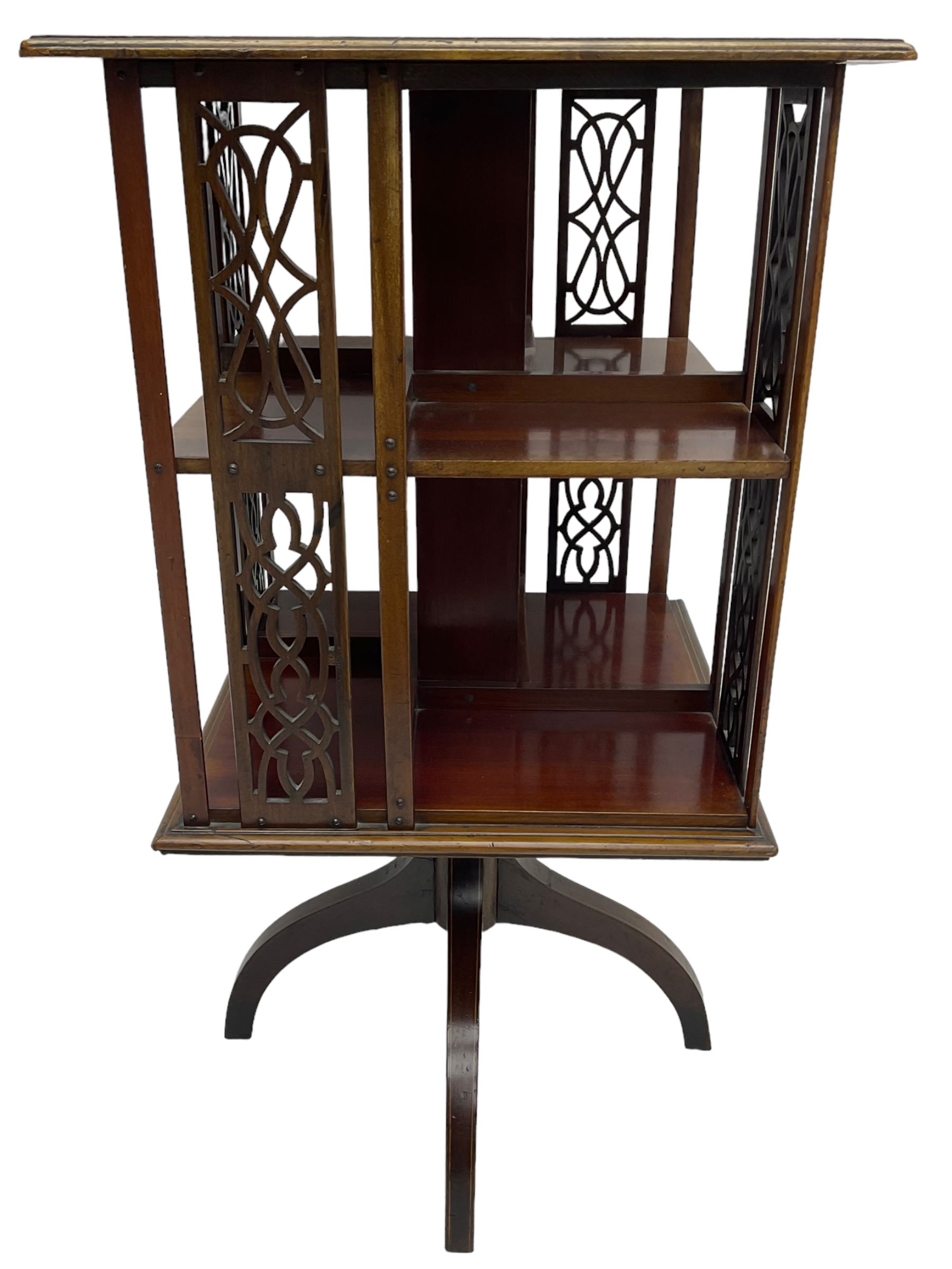 Edwardian mahogany revolving bookcase, square moulded top with satinwood band, two tiers with pierced vertical splats, on four curved supports 