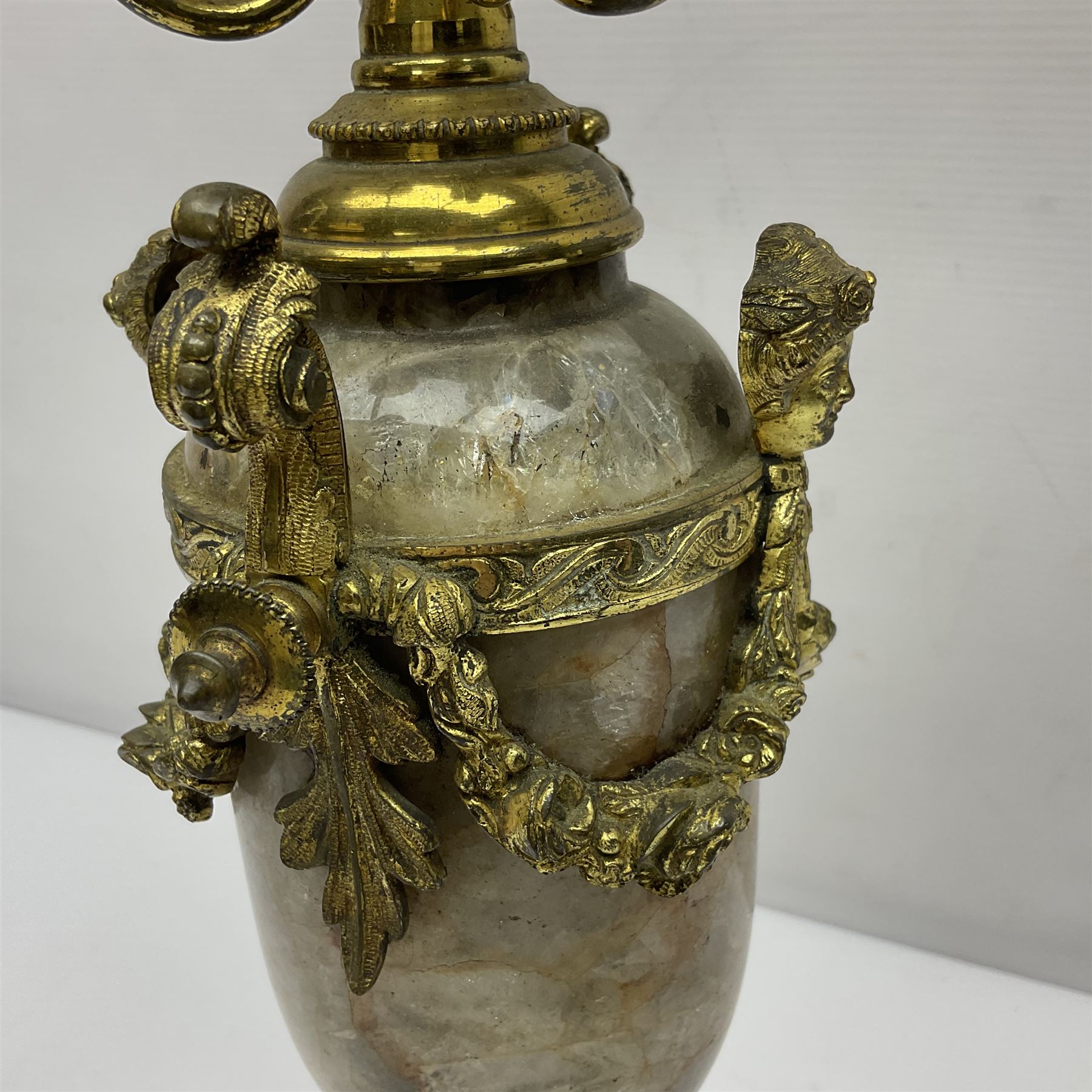 20th century five branch candelabra, with gilded floral garland and female mask decoration, to a marble effect resin urn and stepped base, upon four paw feet, H61cm