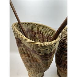 Two rattan baskets, of circular abstract form, together with two crook walking stick, basket H62cm 