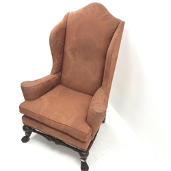 Georgian style mahogany framed high wing back armchair, upholstered in a patterned terracotta studded fabric, turned supports joined by stretchers, W97cm