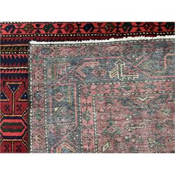 Persian Hamadan red ground rug, the field decorated with geometric motifs, triple band border with repeating design