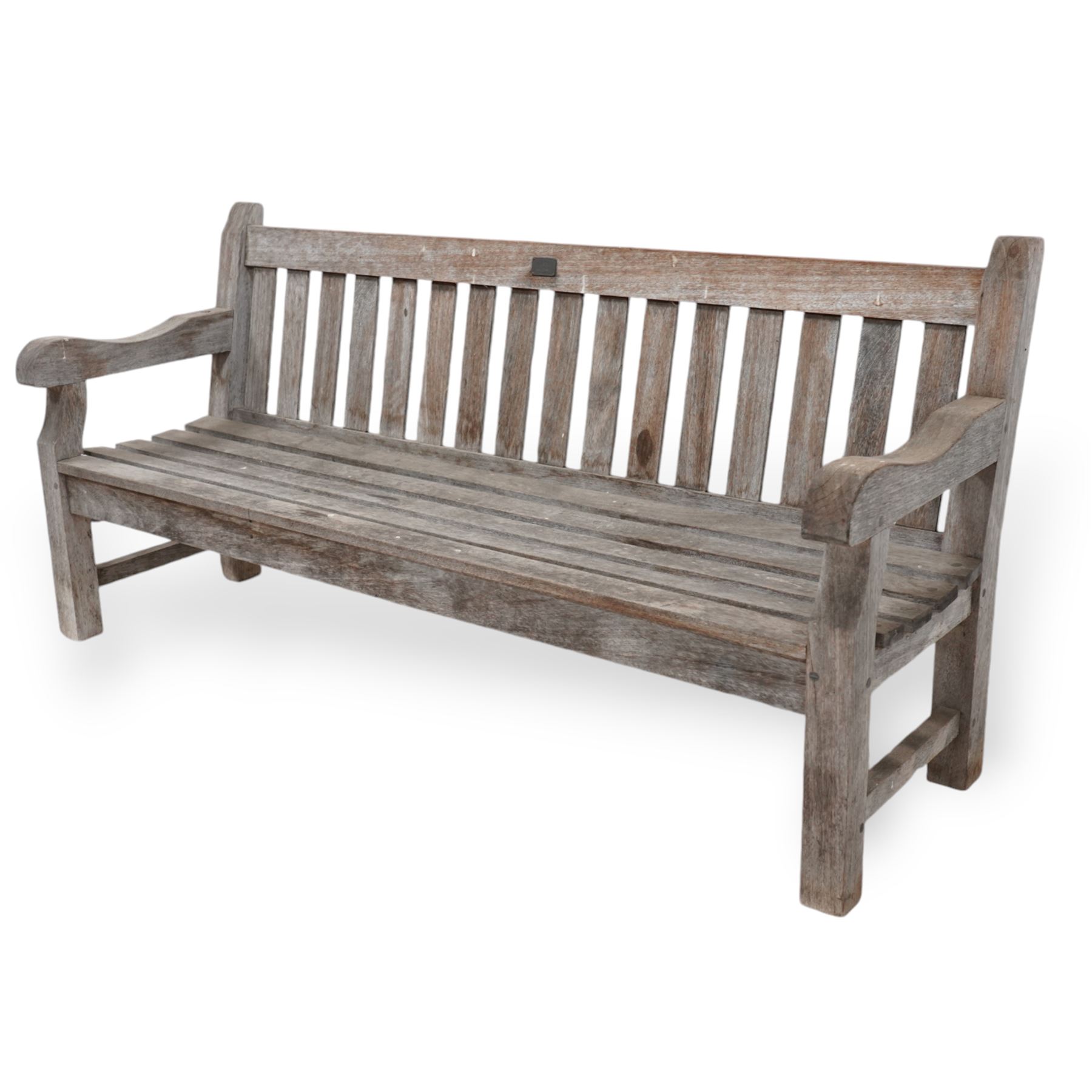 'J.V.T. Ampleforth' - teak garden bench, plain cresting rail with applied maker's plaque over slatted back and seat, on square supports 