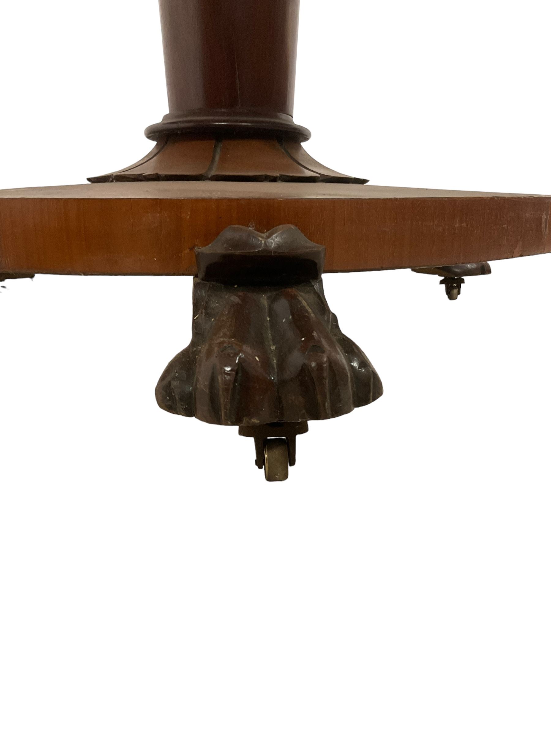 Victorian mahogany breakfast table, circular top with moulded edge, on a tapering pedestal with shaped collar on circular base, raised on three large paw feet