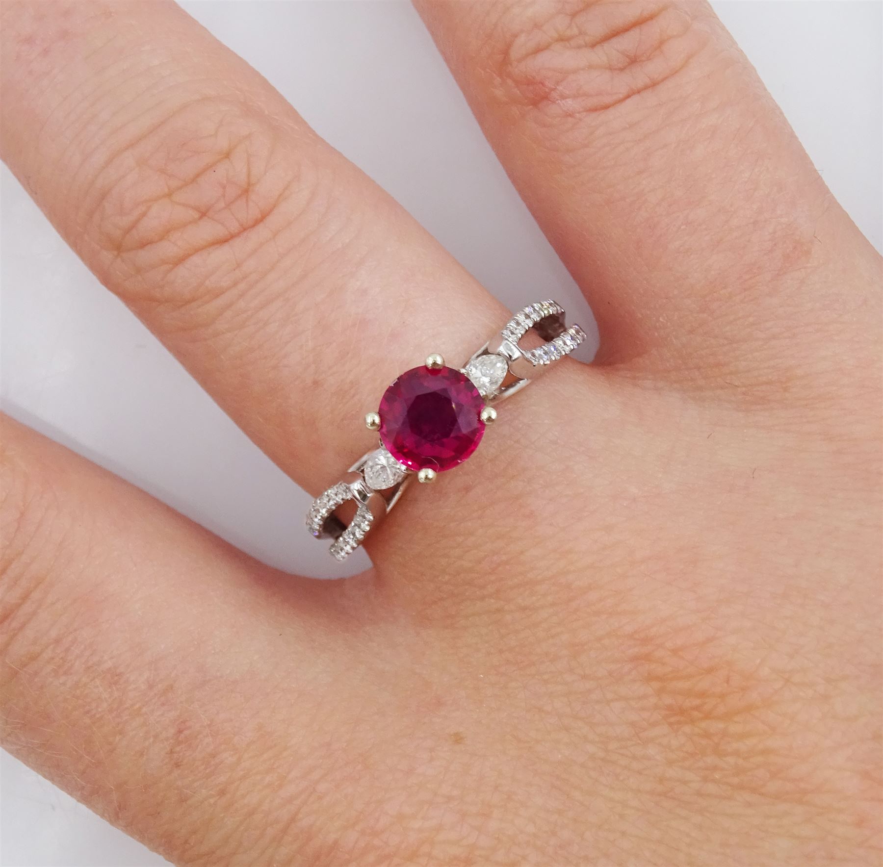 18ct white gold three stone round cut ruby and pear cut diamond ring, with diamond set gallery and two row diamond set shoulders, hallmarked, ruby approx 0.85 carat