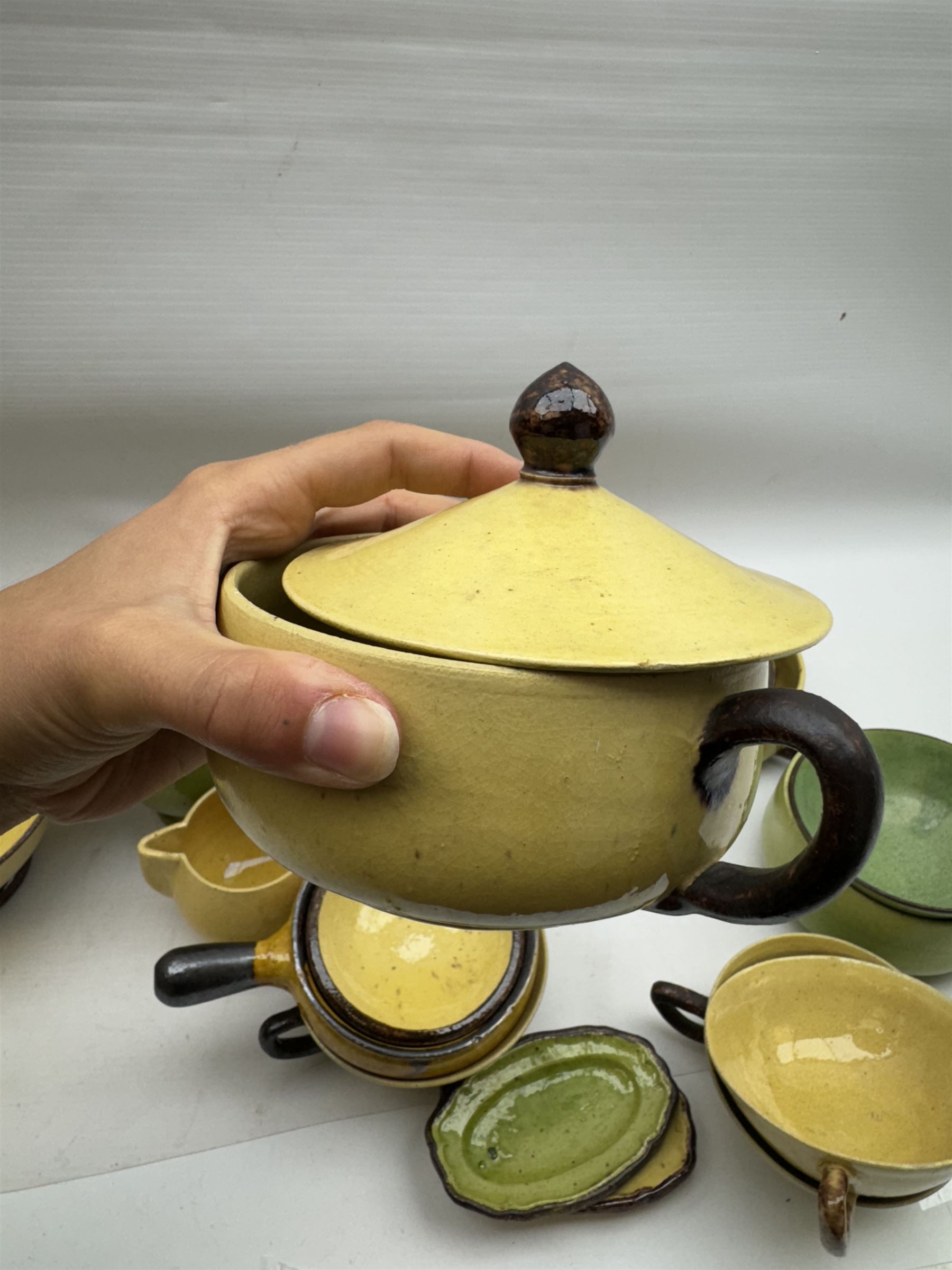 French green and yellow glazed tea and dinner wares by Etienne Noel, including milk jugs, teacups, side plates, bowls etc (43)