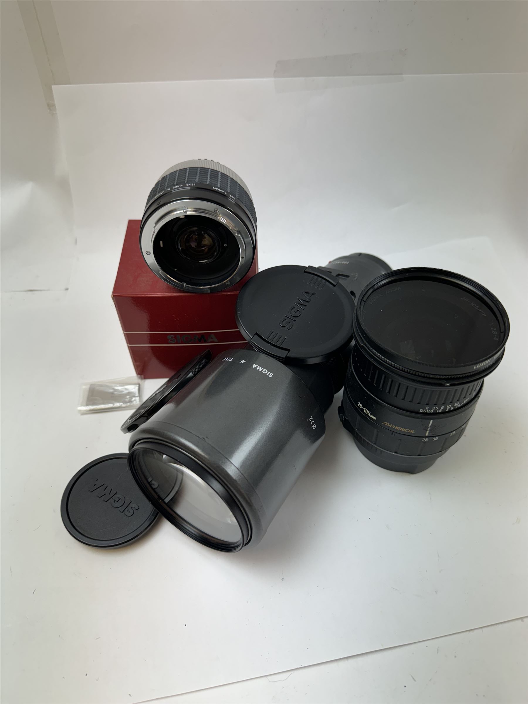 Two Sigma camera lenses, comprising 28-105mm 1:2.8-4 aspherical zoom lens serial no. 1005268, with Luxon CIR polarizer 72mm filter, hood and lens caps, an AF Tele 1:56 f=400mm multi-coated lens, serial no. 3021847, and a Sigma Tele-Macro multi-coated 2x teleconverter, boxed