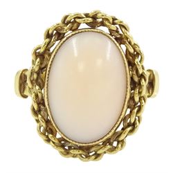 18ct gold single stone coral ring, with chain decoration border, stamped 750