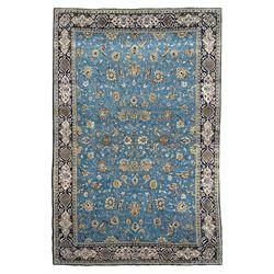 Persian Nain blue ground rug, overall arabesque design, the busy field decorated with interlacing branches and palmettes, indigo ground border with panels decorated with knots and lotus flower motifs, surrounded by trailing branches and flower heads, within guard stripes