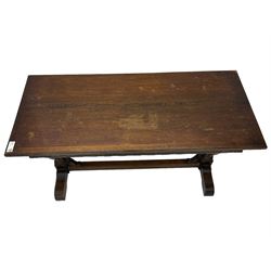 Early 20th century oak extending table, moulded rectangular top, pull-out action with fold-out leaf, on turned cup and cover pedestals and sledge feet, united by moulded stretcher 