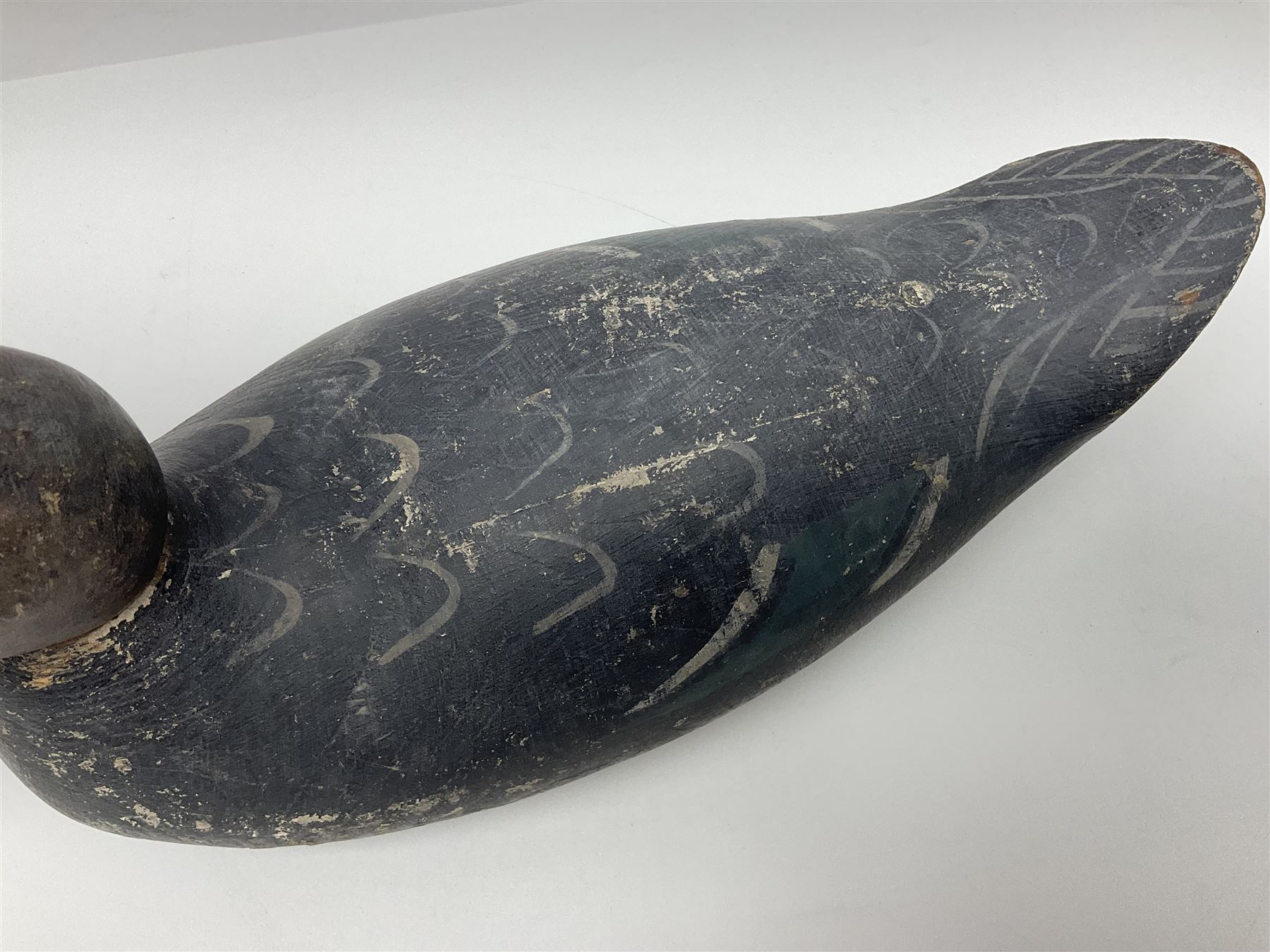 Early 20th century American carved wooden decoy duck, with weight beneath marked CJ Raymond Lead Co Chicago, Ill, H18cm, L38cm 