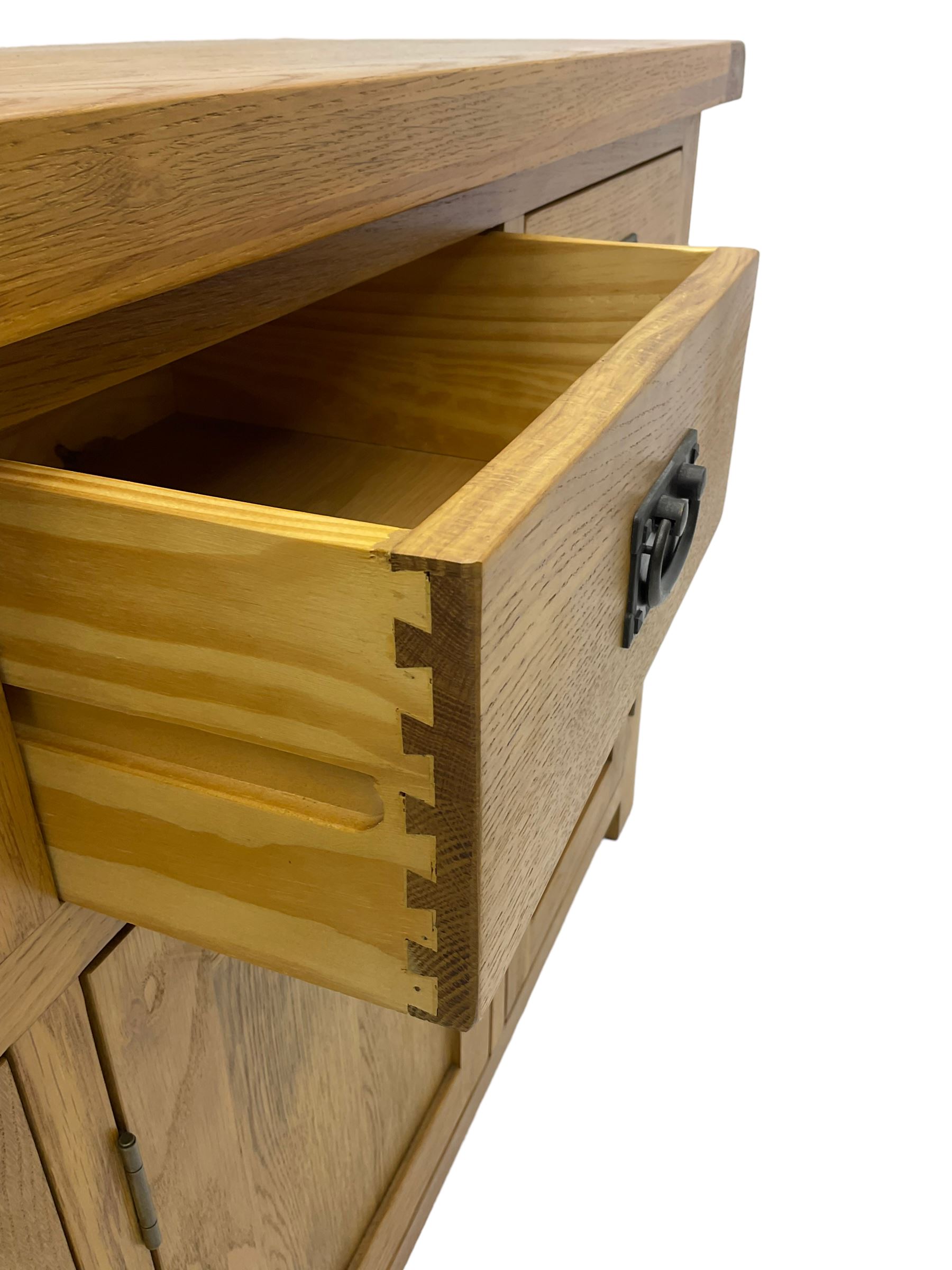 Contemporary light oak sideboard, fitted with three drawers over three panelled cupboards enclosing shelving, on square supports