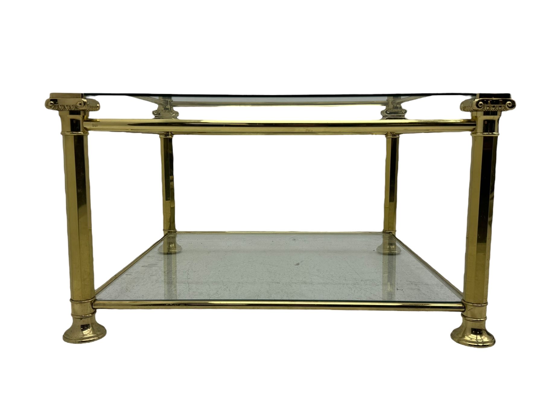 Mid 20th century brass and glass coffee table, square glass top with bevelled edges over undertier, supported by brass columns joined by crossbars, on circular feet