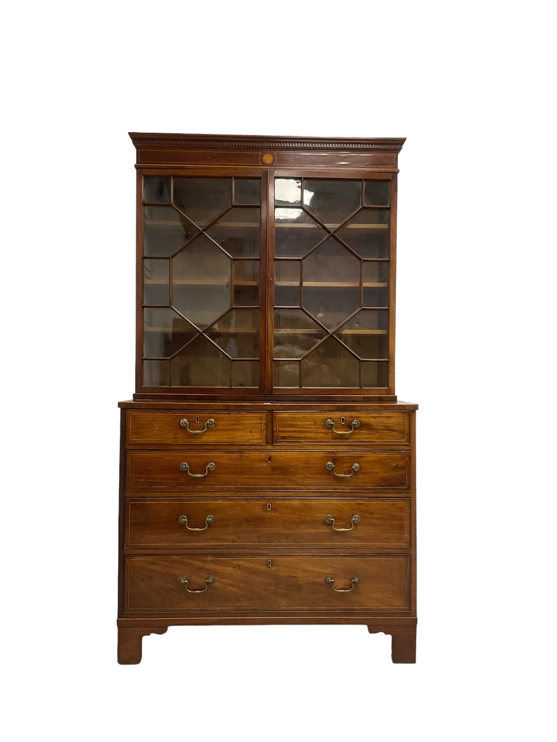 George III mahogany chest of drawers surmounted by a later bookcase, dentil cornice over inlaid frieze and astragal glazed doors, the chest fitted with two short over three long cock-beaded drawers, on bracket feet