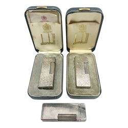 Three Dunhill silver plated lift-arm lighters, of rectangular form with engine turned decoration, marked Dunhill, two with original cases 