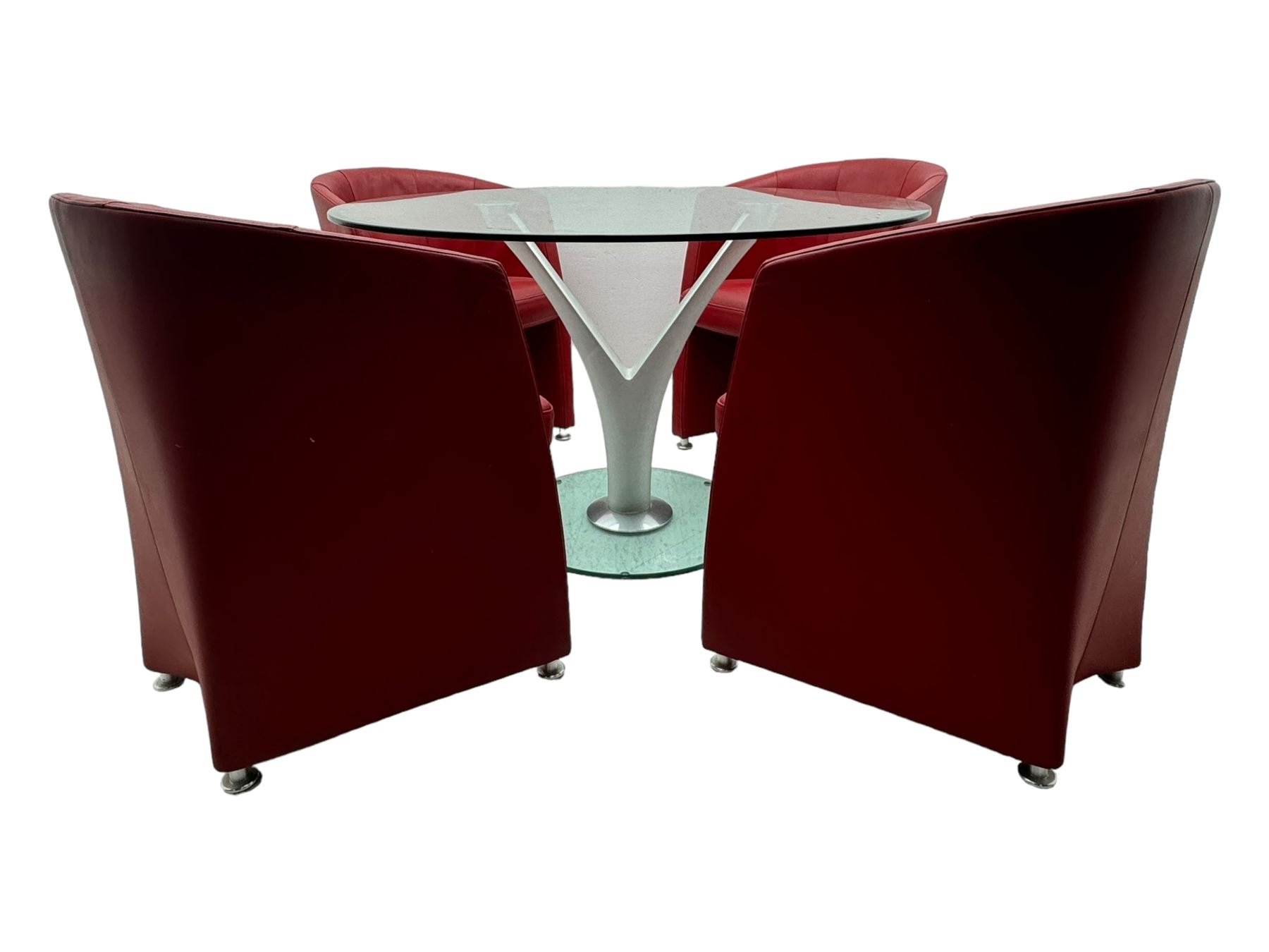 Rolf Benz glass dining table, circular bevelled glass top supported by central Y-shaped brushed metal column, terminating in circular glass base; four red leather tub chairs with curved backrests and vertical stitching, on round chrome feet (5)