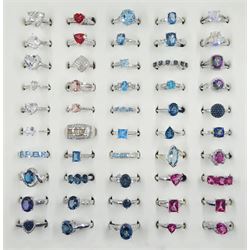 Forty-seven silver topaz rings including blue, mystic, pink and teal and three silver diamond rings including fancy blue and white