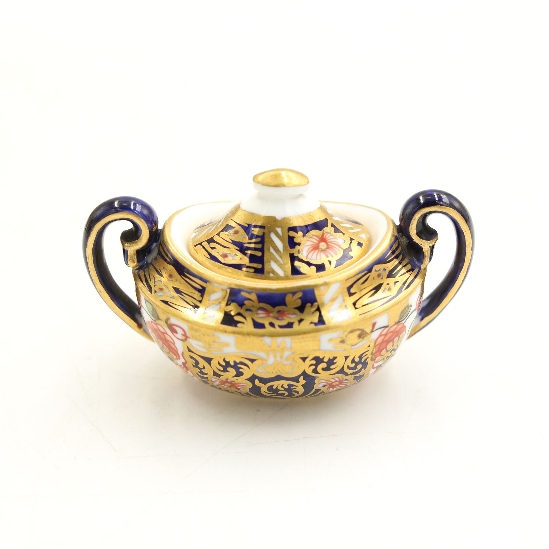 Royal Crown Derby miniature tea set of oval design decorated in Imari design 6299 comprising teapot, two handled sucrier and cover, milk jug and cup and saucer, date code 1905/6 and two small vases pattern 1129, date code 1907 H8.5cm