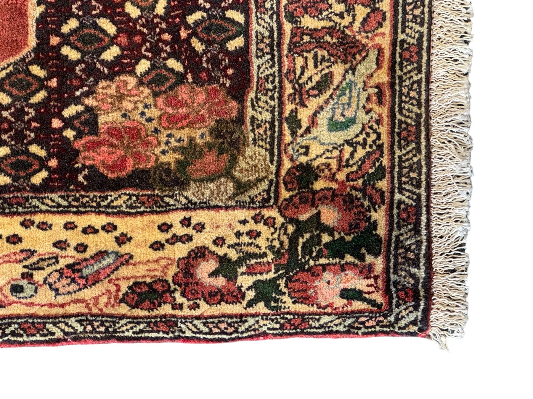 Kurdish rose ground runner rug, set with a series of ten floral medallions on linked field, the border decorated with stylised flower heads and bird motifs 