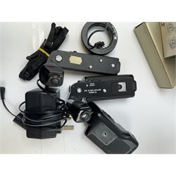 Collection of Canon camera accessories, predominantly for SLR cameras, including flashes, motor drives, quartz date back grips, filters, etc, mostly boxed or cased 