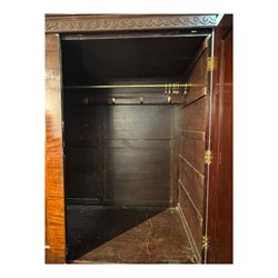 Victorian mahogany linen press, projecting cornice with dentil and scroll detailing, double panelled doors opening to an interior fitted with a brass hanging rail and coat hooks, lower section with two drawers and fitted shelves for additional storage, raised on bracket feet