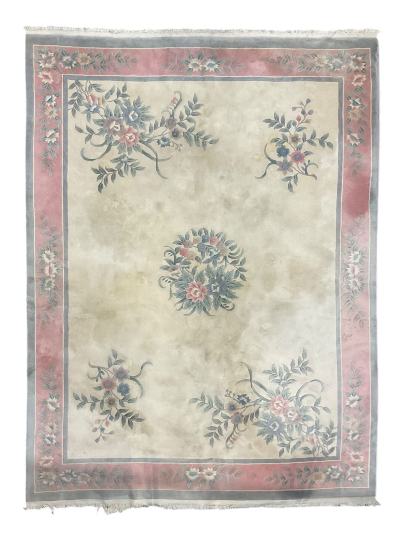 Chinese ivory ground washed woollen carpet, the field decorated with five large floral motifs with extending leafage, the wide rose guard band decorated with further floral patterns