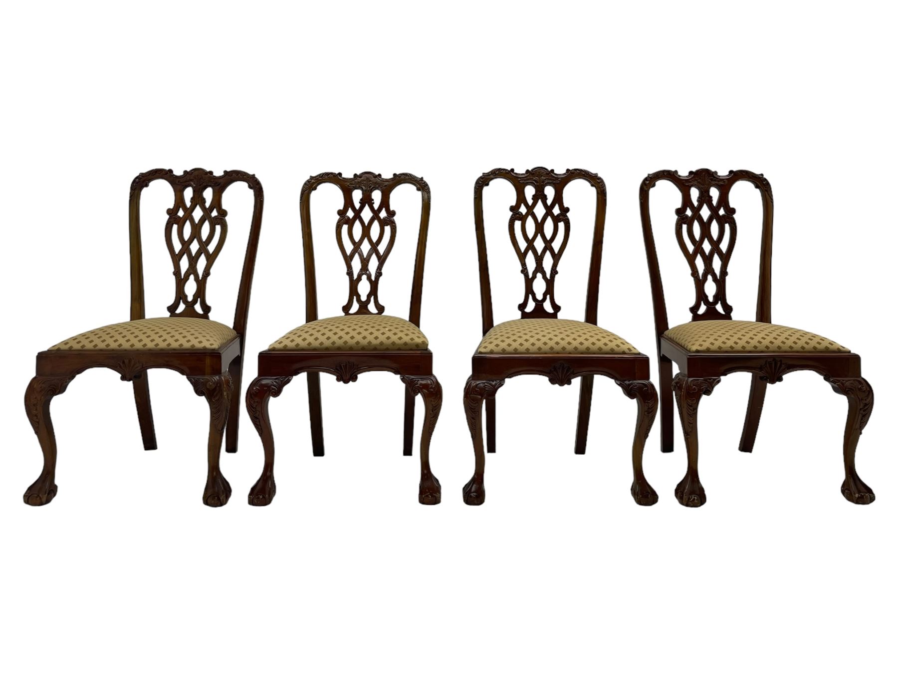 Set of twelve Chippendale design mahogany dining chairs, shaped cresting rail carved with foliage and C-scrolls, pierced interlaced splat with curled leaf decoration, upholstered drop-in seat, moulded seat rails, on scrolled acanthus carved cabriole supports with ball and claw feet 