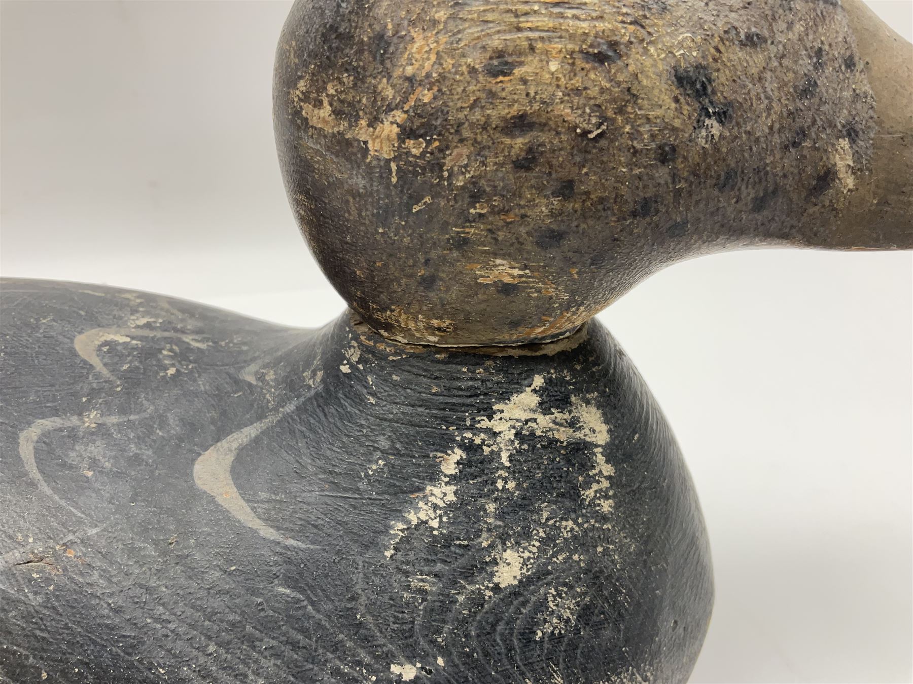 Early 20th century American carved wooden decoy duck, with weight beneath marked CJ Raymond Lead Co Chicago, Ill, H18cm, L38cm 