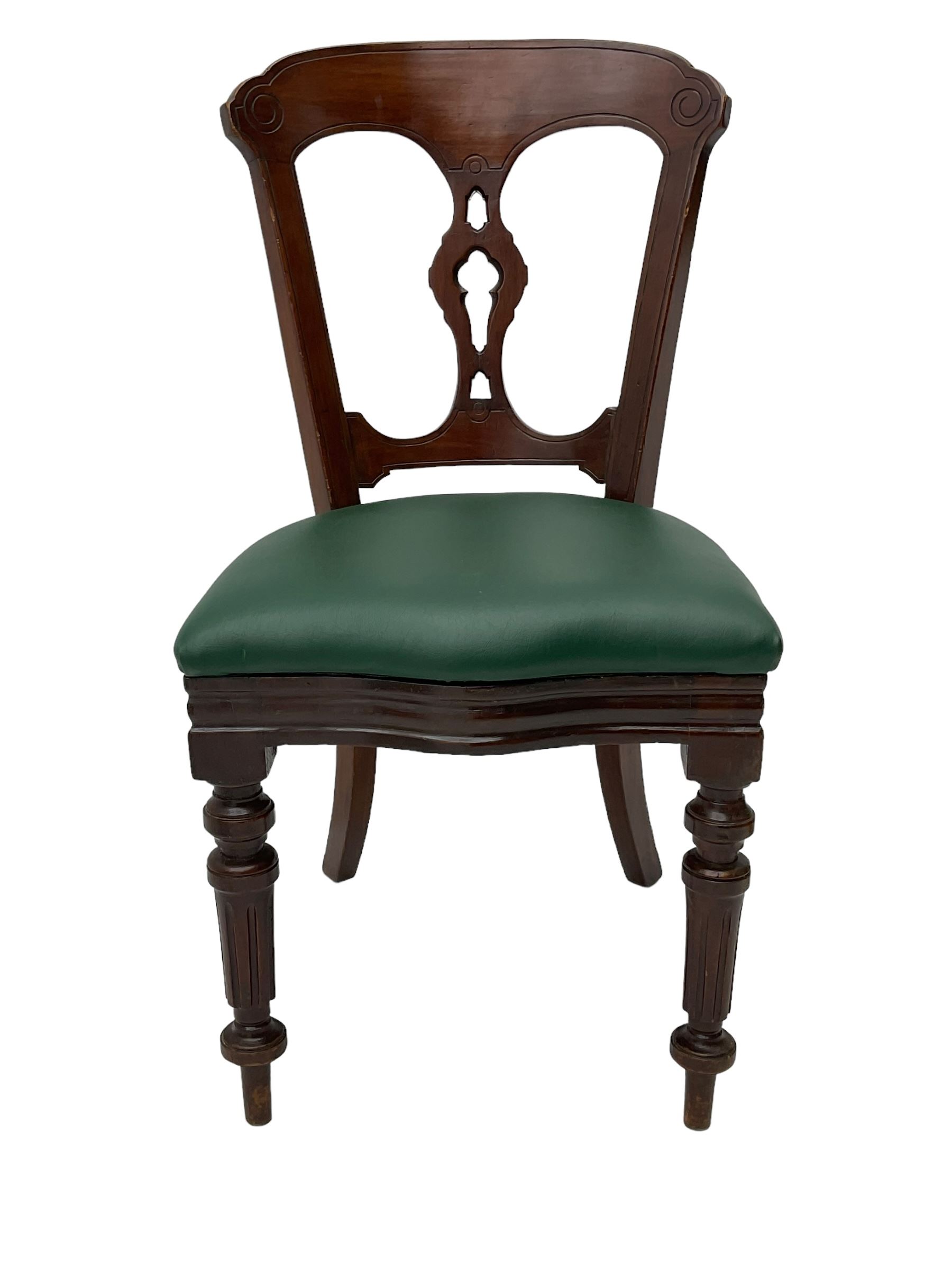 Matched set of twelve Victorian mahogany dining or boardroom chairs, the shaped cresting rail decorated with scrolled decoration, upholstered drop-on seats upholstered in green fabric, on turned supports  